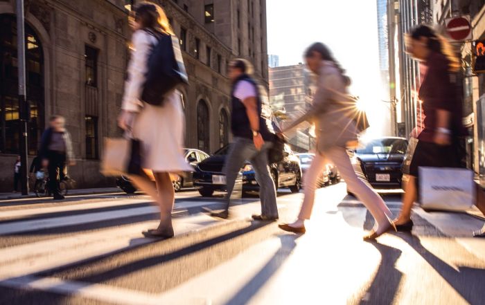 Pedestrians crossing the street in a liveable and affordable neighbourhood in Canada