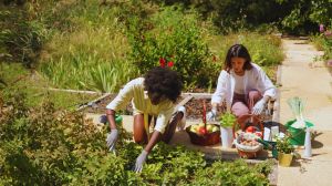 Two women in the garden talking about What Is Homesteading in Canada All About