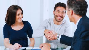 Couple and mortgage advisor discussing Does Your Credit Score Impact Your Mortgage Rate?