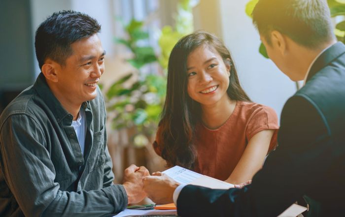 Couple with mortgage adviser discussing if porting a mortgage is worth it