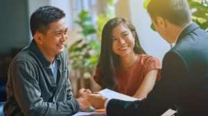 Couple with mortgage adviser discussing if porting a mortgage is worth it